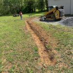 Image of drainage ditch being dug out with construction services by Blue collar construction