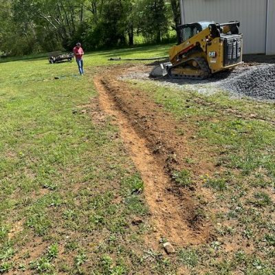 Image of drainage ditch being dug out with construction services by Blue collar construction