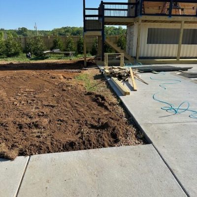 A trench dug and a pipe running through it to